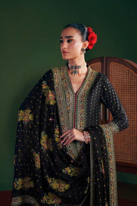 Woman wearing a traditional outfit with intricate patterns and a red flower in her hair against a green background|Midnight Blooms long shirt 3 piece luxury silk outfit
