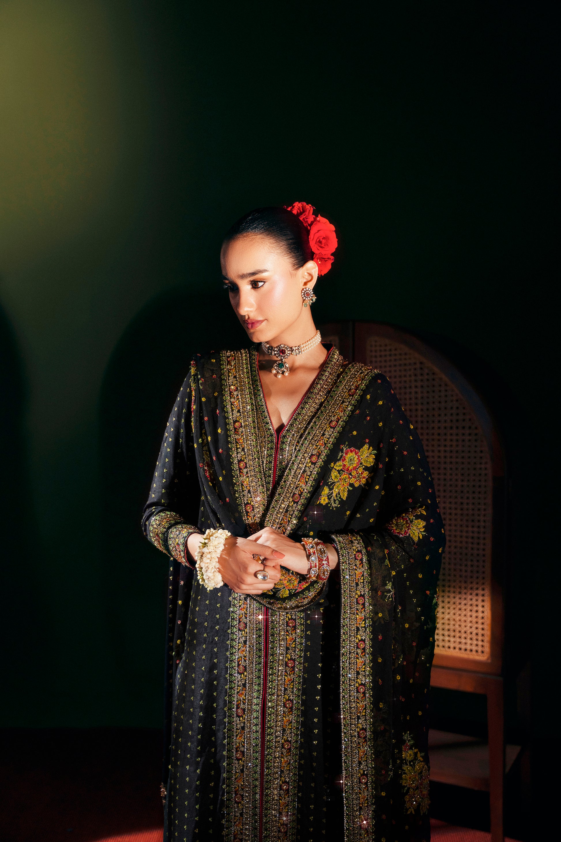 Woman in traditional attire with floral headpiece against a dark background|Chiffon dupatta with embroidered scalloped tassels